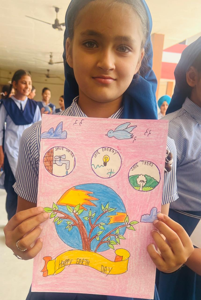 Student with Save Earth craft